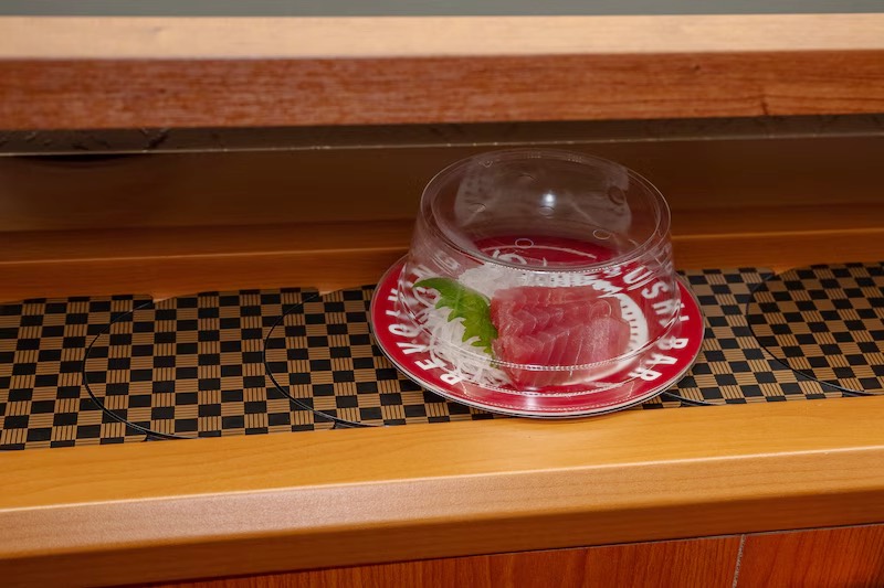 Covered plate of fresh tuna on the conveyor belt at Makoto Staten Island